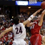 Wisconsin 's Josh Gasser (21) tries to shoot past Arizona's Elliott Pitts (24) during the first half in a regional final NCAA college basketball tournament game, Saturday, March 29, 2014, in Anaheim, Calif. (AP Photo/Jae C. Hong)