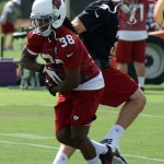 Quarterback Carson Palmer hands the ball off to running back Andre Ellington during OTAs at the Cardinals' Tempe training facility Monday, June 2. (Adam Green/Arizona Sports)