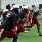 A group of players begins the Cardinals conditioning test at University of Phoenix Stadium in Glendale, Ariz, on July 25. (Adam Green/Arizona Sports)