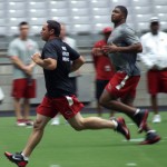 Kicker Jay Feely and defensive end Calais Campbell run during the Cardinals conditioning test at University of Phoenix Stadium in Glendale, Ariz, on July 25. (Adam Green/Arizona Sports)
