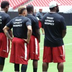 Players watch during the Cardinals conditioning test at University of Phoenix Stadium in Glendale, Ariz, on July 25. (Adam Green/Arizona Sports)