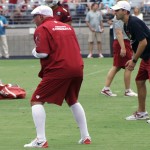 Head coach Bruce Arians crouches while giving instruction during Arizona Cardinals training camp July 27, 2014. (Adam Green/Arizona Sports)