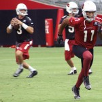 Receiver Larry Fitzgerald runs a route while QB Carson Palmer drops back to pass during Arizona Cardinals training camp July 27, 2014. (Adam Green/Arizona Sports)