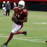 Larry Fitzgerald runs out of bounds with the ball during Arizona Cardinals training camp July 28, 2014. (Adam Green/Arizona Sports)