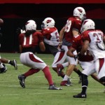Linebacker Kenny Demens steps in front of Larry Fitzgerald to corral an interception during Arizona Cardinals training camp July 29, 2014. (Adam Green/Arizona Sports)