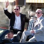 Majority owner Ron Shurts (left) and head coach Kevin Guy wave to the crowd while president Joe Windham drives during the Arizona Rattlers Championship Parade Wednesday, Aug. 26, 2014. (Photo: Vince Marotta/Arizona Sports)