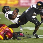 Southern California cornerback Kevon Seymour (13) tackles Arizona State running back Kalen Ballage (9) during the first half of an NCAA college football game, Saturday, Oct. 4, 2014, in Los Angeles. (AP Photo/Gus Ruelas)