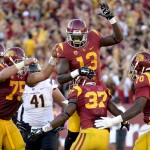 Southern California center Max Tuerk (75), running back Javorius Allen (37) and guard Aundrey Walker (70) celebrate teammate tight end Bryce Dixon's (13) touchdown during the first half of an NCAA college football game against Arizona State, Saturday, Oct. 4, 2014, in Los Angeles. (AP Photo/Gus Ruelas)