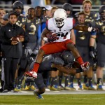 Arizona running back Terris Jones-Grigsby (24) jumps over UCLA defensive back Fabian Moreau (10) for a first down during the first half of an NCAA college football game, Saturday, Nov. 1, 2014, in Pasadena, Calif. (AP Photo/Gus Ruelas)