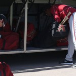 Players make sure their equipment is all set before boarding the bus. (Photo by Stephen DeLorenzo/Cronkite News)