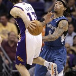 Phoenix Suns' Steve Nash (13) dishes the ball off behind his back to a teammate as Minnesota Timberwolves' Michael Beasley (8) defends during the first quarter of an NBA basketball game Wednesday, Dec. 15, 2010, in Phoenix. (AP Photo)