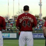 Nick Ahmed and Paul Goldschmidt stand with a trainer during the National Anthem. Photo by Zachary Holland/Cronkite News