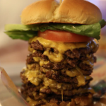 This burger includes nine patties and nine slices of cheese.