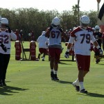Members of the Arizona Cardinals' offensive line walk off the field following the team's OTA practice Tuesday, May 19. (Photo by Adam Green/Arizona Sports)