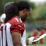 Receiver Larry Fitzgerald goes over some notes during Arizona Cardinals mini-camp Tuesday, June 9. (Photo by Adam Green/Arizona Sports)