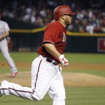 Arizona Diamondbacks' Welington Castillo, front, rounds the bases after hitting a home run against Los Angeles Angels' Hector Santiago, rear, during the fourth inning of a baseball game Wednesday, June 17, 2015, in Phoenix. (AP Photo/Ross D. Franklin)