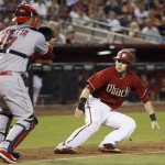 Los Angeles Angels' Chris Iannetta, left, runs down Arizona Diamondbacks' Chris Owings just prior to tagging him out between third and home during the sixth inning of a baseball game Wednesday, June 17, 2015, in Phoenix. (AP Photo/Ross D. Franklin)