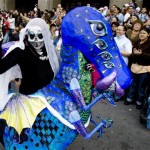 A man dressed as an Alebrije takes part in a parade in Mexico City, Saturday, Oct. 20, 2007. Alebrijes are brightly-colored Mexican folk art sculptures of fantastical animal-like creatures. (AP Photo/Eduardo Verdugo)