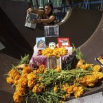 A woman places a picture on a traditional Day of the Dead altar dedicated to soldiers killed in the war in Iraq outside the U.S. Embassy in Mexico City, Saturday, Oct. 27, 2007. Mexicans honor loved ones who have died by building Day of the Dead altars in their honor, a tradition which coincides with All Saints Day and All Souls Day celebrated on Nov. 1 and 2. (AP Photo/Gregory Bull)