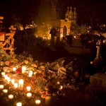 A woman sleeps next to a grave during the ' Noche de los Angelitos' or 'Night of the Little Angels', part of the traditional celebrations leading to the Day of the Dead at the Tzintzuntzan Cemetery, in Mexico, early Thursday, Nov. 1, 2007. The Patzcuaro's lake region, on the western Mexican state of Michoacan, is home to some of the most traditional rituals related to the Day of the Dead, to be held in Mexico the first two days of November. (AP Photo/Guillermo Arias)