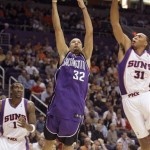 Sacramento Kings guard Francisco Garcia, center, of the Dominican Republic, lays in a basket between Phoenix Suns center Amare Stoudemire, left, and forward Shawn Marion in the third quarter of an NBA basketball game Wednesday, Nov. 21, 2007, in Phoenix. (AP Photo/Paul Connors)