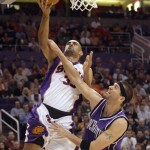 Phoenix Suns forward Grant Hill, left, is fouled by Sacramento Kings center Brad Miller, right, as Hill drives to the basket in the second quarter of an NBA basketball game Wednesday, Nov. 21, 2007, in Phoenix. (AP Photo/Paul Connors)