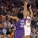 Phoenix Suns guard Steve Nash, right, shoots a 3-point field goal over Sacramento Kings center Mikki Moore, left, in the first quarter of an NBA basketball game Wednesday, Nov. 21, 2007, in Phoenix. (AP Photo/Paul Connors)