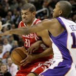 Houston Rockets' Shane Battier, left, tries to drive past Phoenix Suns' Raja Bell in the first quarter of an NBA basketball game Wednesday, Nov. 28, 2007, in Phoenix. (AP Photo/Ross D. Franklin)
