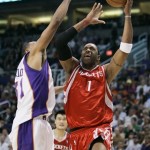 Houston Rockets' Tracy McGrady (1) drives past Phoenix Suns' Shawn Marion in the second quarter of an NBA basketball game Wednesday, Nov. 28, 2007, in Phoenix. (AP Photo/Ross D. Franklin)