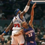 Phoenix Suns forward Grant Hill (33) and New York Knicks forward Quentin Richardson (23) reach for a loose ball in the first half of the Suns' 115-104 victory in an NBA basketball game in New York, Sunday, Dec. 2, 2007. Hill had a season-high 28 points. (AP Photo/Kathy Willens)