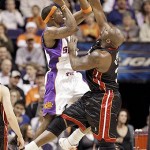 Suns center Amare Stoudemire is fouled by Miami Heat center Shaquille O'Neal during the first quarter of an NBA basketball game Monday. (AP Photo/Matt York)