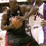 Miami Heat center Shaquille O'Neal goes for two against Phoenix Suns center Amare Stoudemire during the first quarter of an NBA basketball game Monday. (AP Photo/Matt York)