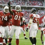 Arizona Cardinals' Anquan Boldin (81) celebrates his touchdown with teammate Reggie Wells (74) as Atlanta Falcons' Michael Boley (59) and Lawyer Milloy (36) look away during the second quarter of an NFL football game Sunday, Dec. 23, 2007, in Glendale, Ariz. (AP Photo/Paul Connors)