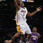 Los Angeles Lakers' Trevor Ariza (3) dunks over Phoenix Suns' Grant Hill in first half of their NBA basketball game, Tuesday, Dec. 25, 2007 in Los Angeles. (AP Photo/Gus Ruelas)