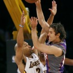 Phoenix Sun's Steve Nash, right, makes a cross-court pass over Los Angeles Lakers' Derek Fisher (2) in first half of their NBA basketball game, Tuesday, Dec. 25, 2007 in Los Angeles. The Lakers won 122-115. (AP Photo/Gus Ruelas)