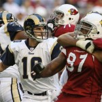 St. Louis Rams quarterback Marc Bulger, left, looks for a receiver to pass to as Rams offensive tackle Brandon Gorin, right, blocks Arizona Cardinals linebacker Calvin Pace (97) in the first quarter of an NFL football game Sunday, Dec. 30, 2007 in Glendale, Ariz. The Cardinals defeated the Rams 48-19. (AP Photo/Ross D. Franklin)