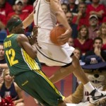 Arizona's Daniel Dillon, right, saves the ball from going out of bounds as Oregon's Tajuan Porter (12) tries to stop during the second half of a college basketball game at McKale Center in Tucson, Ariz., Saturday, Jan. 5, 2008. Oregon won 84-74. (AP Photo/John Miller)