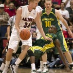Arizona's Chase Budinger (34) knocks over the attempted defense of Oregon's Churchill Odia right, as Oregon's Maarty Leunen watches (10) during the second half of a college basketball game at McKale Center in Tucson, Ariz., Saturday, Jan. 5, 2008. Oregon won 84-74. (AP Photo/John Miller)