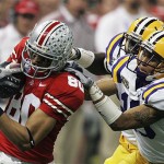 Ohio State wide receiver Brian Robiskie (80) is stopped by LSU cornerback Jonathan Zenon (19) in the first half during the BCS championship college football game at the Louisiana Superdome in New Orleans, Monday, Jan. 7, 2008. (AP Photo/Keith Srakocic)