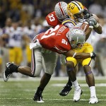 LSU wide receiver Demetrius Byrd, right, is stopped by Ohio State safety Anderson Russell (21) and linebacker James Laurinaitis (33) in the first half during the BCS championship college football game at the Louisiana Superdome in New Orleans, Monday, Jan. 7, 2008. (AP Photo/Nam Y. Huh)