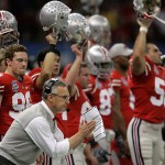 Ohio State coach Jim Tressel and his team cheer during the first quarter of BCS championship college football game against LSU at the Louisiana Superdome in New Orleans, Monday, Jan. 7, 2008. (AP Photo/Keith Srakocic)