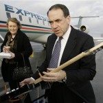 Republican Presidential hopeful, former Arkansas Gov. Mike Huckabee, right, accompanied by his with wife Janet, shows a guitar that the volunteers signed and gave him, prior to boarding a plane in Manchester, N.H., Wednesday, Jan. 9, 2008, en route to South Carolina after the New Hampshire Presidential Primary. (AP Photo/Alex Brandon)
