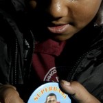 Christian Spiegel, 12, pins on a button supporting a Barack Obama, portrayed as Superman, named "Superbama", while in waiting in line for an Obama event in Jersey City, N.J., Wednesday, Jan. 9, 2008. (AP Photo/Seth Wenig)
