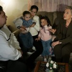 Democratic presidential hopeful Sen. Hillary Rodham Clinton, D-N.Y. speaks to the Santana family in their home as she canvasses a neighborhood in Las Vegas, Nev., Thursday, Jan. 10, 2008. From left is Gilberto Santana, his wife Elizabeth with their son Gilberto Jr., 2, and daughter Xitlali, 4. (AP Photo/Elise Amendola)