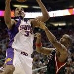 Phoenix Suns guard Boris Diaw, left, of France, has the ball knocked away by Milwaukee Bucks guard Michael Redd, right, in the third quarter of an NBA basketball game Saturday, Jan. 11, 2008, in Phoenix. The Suns won 122-114. (AP Photo/Paul Connors)