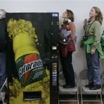 Supporters for Democratic presidential hopeful Sen. Barack Obama, D-Ill., stand on chairs and peer over and around a vending machine during a town hall meeting in Carson City, Nevada Monday, Nevada Jan. 14, 2008. (AP Photo/Charles Rex Arbogast)