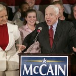 Republican presidential hopeful Sen. John McCain, R-Ariz., addresses a crowd as his wife Cindy, left, watches during a watch party campaign event, in Charleston, S.C., Tuesday, Jan. 15, 2008, following primary voting in Michigan. (AP Photo/Steven Senne)