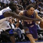 Phoenix Sun's Steve Nash (13) drives on Los Angeles Clippers' Tim Thomas, left in the first half of their NBA basketball game, Tuesday. (AP Photo/Gus Ruelas)
