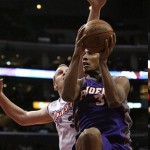 Los Angeles Clippers Chris Kaman, left, attempts to stop Phoenix Suns' Boris Diaw (3) as he drives to the basket in the first half of their NBA basketball game, Tuesday. (AP Photo/Gus Ruelas)