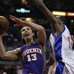 Phoenix Suns' Steve Nash (13) drives pass Los Angeles Clippers' Quinton Ross, left, in the first half of their NBA basketball game, Tuesday. (AP Photo/Gus Ruelas)